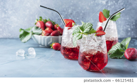 Red cocktail with ice and fresh strawberry 66125481