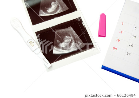 Positive white plastic pregnancy test with calendar isolated on white background. 66126494