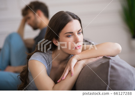 Young woman sit looking upset after a bad talk with her husband 66127288