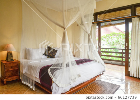 Cozy canopy bed in bedroom 66127739