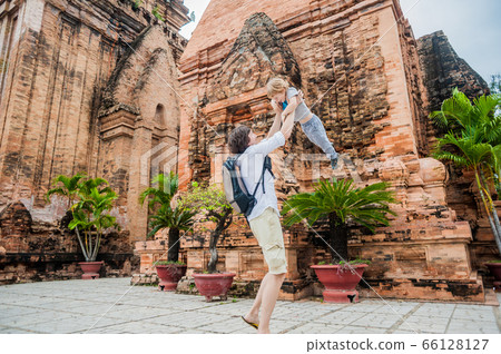 Father and Toddler Son tourists in Vietnam. Dad throws up his . Po Nagar Cham Tovers. Asia Travel concept. 66128127