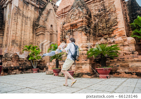Father and Toddler Son tourists in Vietnam. Dad throws up his . Po Nagar Cham Tovers. Asia Travel concept. Father and Toddler Son tourists in Vietnam. Dad throws up his . Po Nagar Cham Tovers. Asia Travel concept. 66128146
