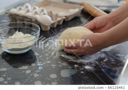 Woman hands preparing dough 66128461