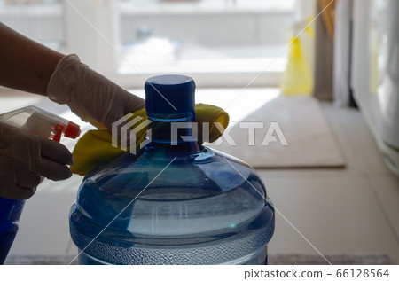 The woman disinfects the carboy The woman disinfects the carboy 66128564