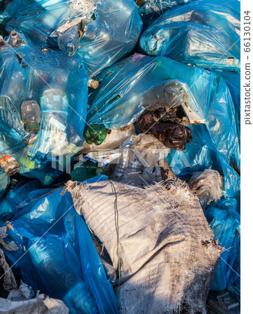 Piles of garbage in plastic bin bags. Piles of garbage in plastic bin bags. 66130104