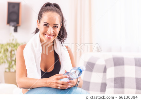 Portrait of a smiling brunette with a white towel Portrait of a smiling brunette with a white towel 66130384