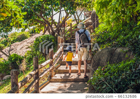 Father and son travelers at the Hon Chong cape, Garden stone, popular tourist destinations at Nha Trang. Vietnam Father and son travelers at the Hon Chong cape, Garden stone, popular tourist destinations at Nha Trang. Vietnam 66132686