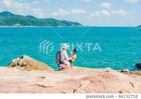 Father and son travelers at the Hon Chong cape, Garden stone, popular tourist destinations at Nha Trang. Vietnam 66132758