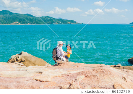 Father and son travelers at the Hon Chong cape, Garden stone, popular tourist destinations at Nha Trang. Vietnam 66132759