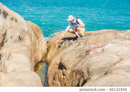 Father and son travelers at the Hon Chong cape, Garden stone, popular tourist destinations at Nha Trang. Vietnam 66132848