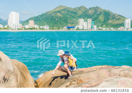 Father and son travelers at the Hon Chong cape, Garden stone, popular tourist destinations at Nha Trang. Vietnam 66132858
