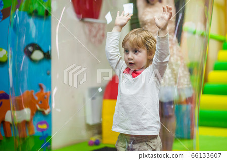 Boy at the festival stands among soap bubbles 66133607