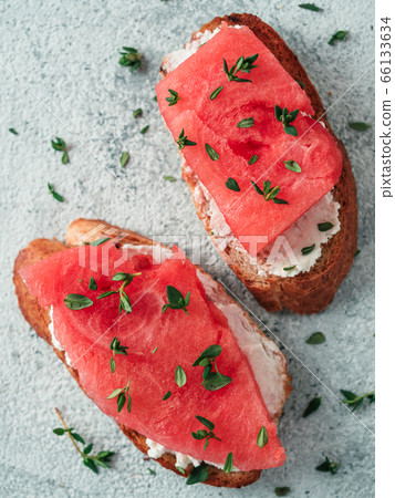 Toasts with watermelon, soft cheese and thyme Toasts with watermelon, soft cheese and thyme 66133634