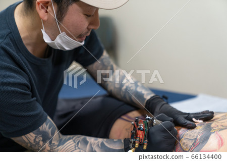 Tattooist tattoo on the back 66134400