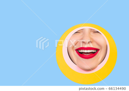 Female face with red lips peeking throught circle in blue background Female face with red lips peeking throught circle in blue background 66134490