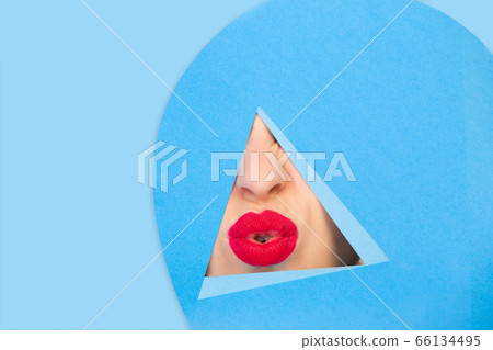 Female red lips peeking throught triangle in blue background Female red lips peeking throught triangle in blue background 66134495