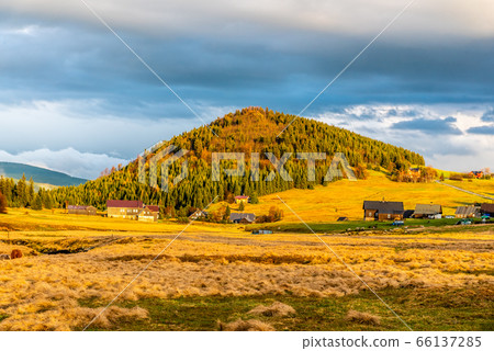 Bukovec mountain above Jizerka village at sunset time. Spring in Jizera Mountains, Czech Republic. Bukovec mountain above Jizerka village at sunset time. Spring in Jizera Mountains, Czech Republic. 66137285