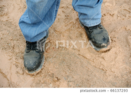 SERDANG, MALAYSIA -OCTOBER 26, 2015: Construction workers wearing safety boots to protect their toe and feet in the construction site. SERDANG, MALAYSIA -OCTOBER 26, 2015: Construction workers wearing safety boots to protect their toe and feet in the construction site. 66137293