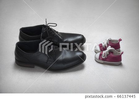 Father with Child Metaphor, baby and adult shoes  66137445