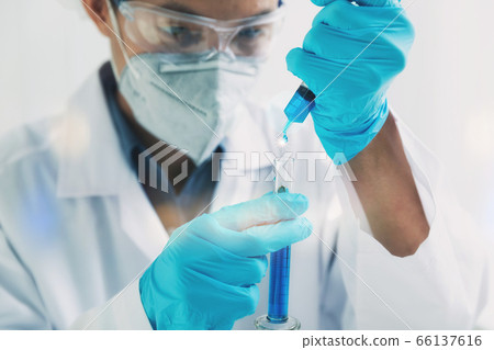 Researcher or scientists loads liquid sample into test tube. Researcher or scientists loads liquid sample into test tube. 66137616