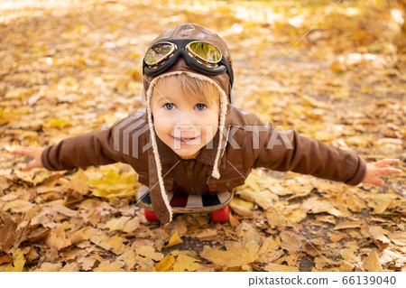 Happy child having fun outdoor in autumn park 66139040