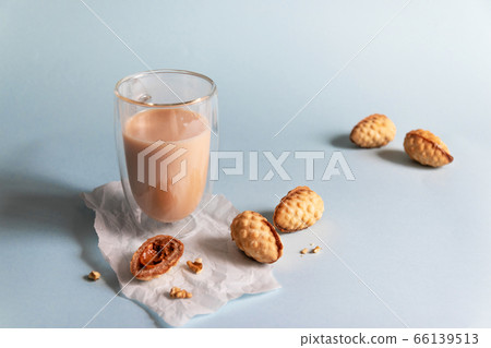 Hot coffee with milk and cookies on a blue background Hot coffee with milk and cookies on a blue background 66139513