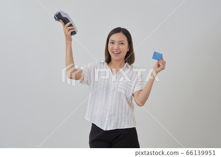 Thai woman presenting credit card for making Thai woman presenting credit card for making 66139951