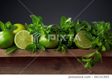 Fresh green mint and limes on a old wooden table. 66141905