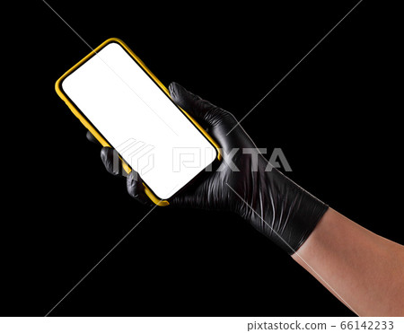 Hand in black glove holding mobile phone with blank screen isolated on black Hand in black glove holding mobile phone with blank screen isolated on black 66142233