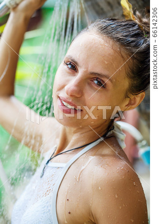 beautiful girl takes a shower on the beach beautiful girl takes a shower on the beach 66142306