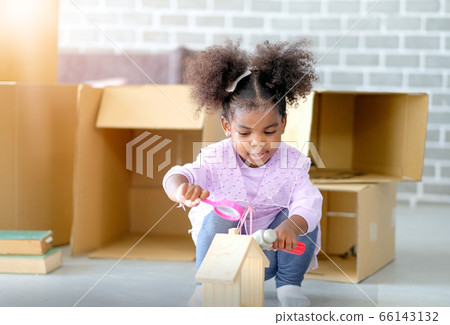 One young African american girls play toys and look fun and enjoy with paper box or carton One young African american girls play toys and look fun and enjoy with paper box or carton 66143132