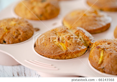 Delicious muffin with orange on a wooden table. Delicious muffin with orange on a wooden table. 66143568