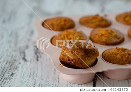 Delicious muffin with orange on a wooden table. Delicious muffin with orange on a wooden table. 66143570