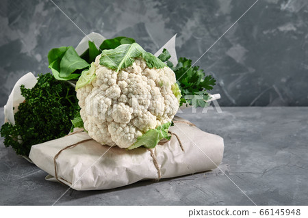 Fresh cauliflower on a gray concrete background. on packaging material, paper bags, eco-friendly packaging. Healthy eating concept, close up 66145948