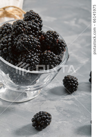 Blackberry on a black background, close-up, fresh berry in a gourd on a concrete background. copies of the space. Blackberry on a black background, close-up, fresh berry in a gourd on a concrete background. copies of the space. 66145975