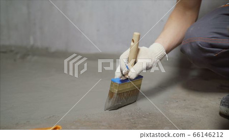 Waterproofing concrete mortar. The master puts waterproofing on a concrete floor with a brush. Waterproofing concrete mortar. The master puts waterproofing on a concrete floor with a brush. 66146212