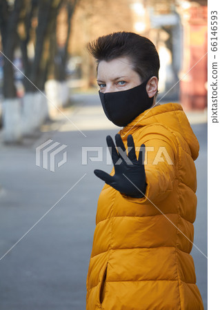 Middle aged european woman in protective black Middle aged european woman in protective black 66146593
