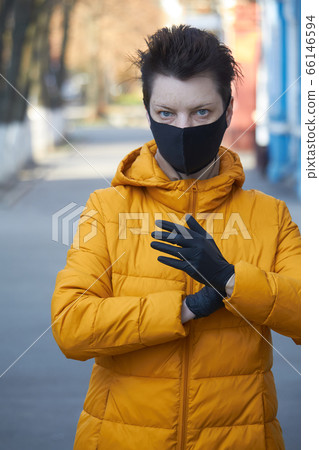 Middle aged european woman in protective black Middle aged european woman in protective black 66146594