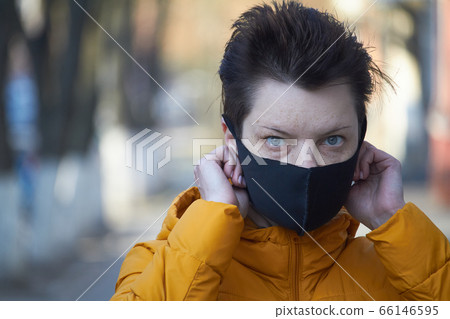 Middle aged european woman in protective black Middle aged european woman in protective black 66146595