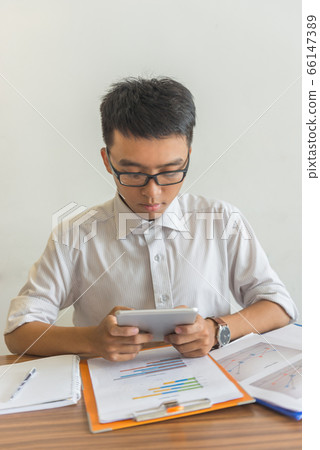 Portrait of young businessman using tablet 66147389