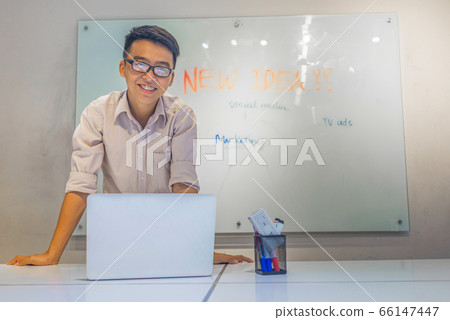 Happy young man making presentation in conference room 66147447