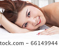 Smiling asian women on bed 66149944