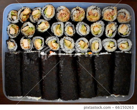 Home made sushi rolls in a container 66150263