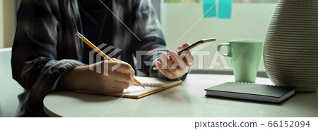 Female freelancer sitting decide window and noting Female freelancer sitting decide window and noting 66152094