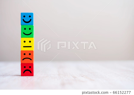 Emotion face symbol on yellow wooden cube blocks. Emotion face symbol on yellow wooden cube blocks. 66152277