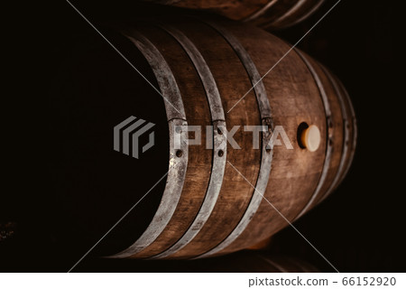 Vintage old oak barrels of wine, cognac in the wine dark vaults of the winery 66152920