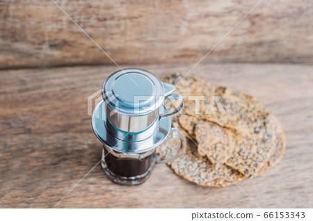 'Phin' traditional Vietnamese coffee maker, place on the top of glass, add ground coffee then pour hot water and wait until the coffee dripping into the glass. The Vietnamese Sesame Rice Cracker is 'Phin' traditional Vietnamese coffee maker, place on the top of glass, add ground coffee then pour hot water and wait until the coffee dripping into the glass. The Vietnamese Sesame Rice Cracker is 66153343