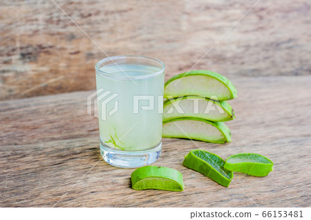 Aloe vera pieces and aloe gel in the glass on an old dark wood background Organic cosmetics concept Aloe vera pieces and aloe gel in the glass on an old dark wood background Organic cosmetics concept 66153481
