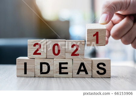 Businessman hand holding wooden cube with block 66153906