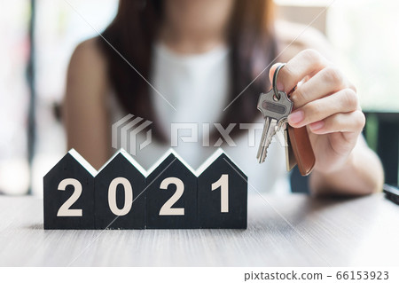 Young Businesswoman hands holding key and wooden 66153923